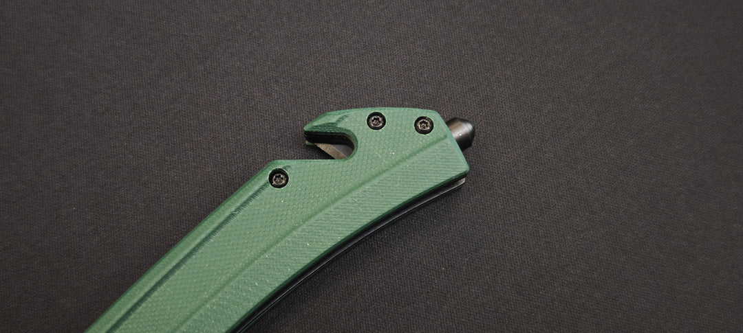 K25 - 25235 - Couteau tactique manche G10 vert lame dentée 9 cm avec coupe-ceinture