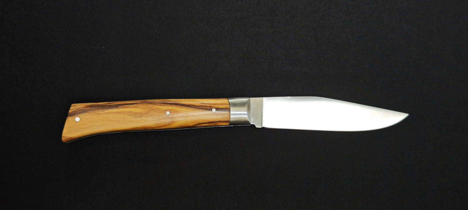 Détail du manche en bois d'olivier du couteau artisanal L'Alpin