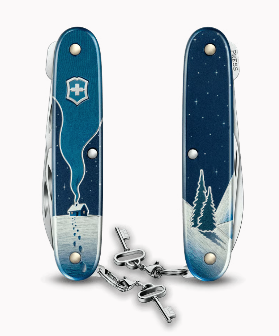 Décor hivernal représentant une maison éclairée sur le manche du Victorinox Winter Magic 2026.